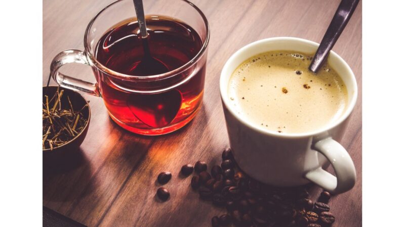 Tazza di tè e caffè su un tavolo con sfondo naturale.